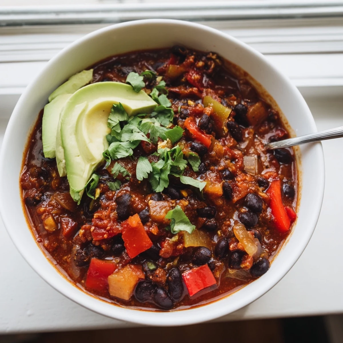 Hearty Spicy Black Bean Chili simmering with colorful veggies and robust spices.