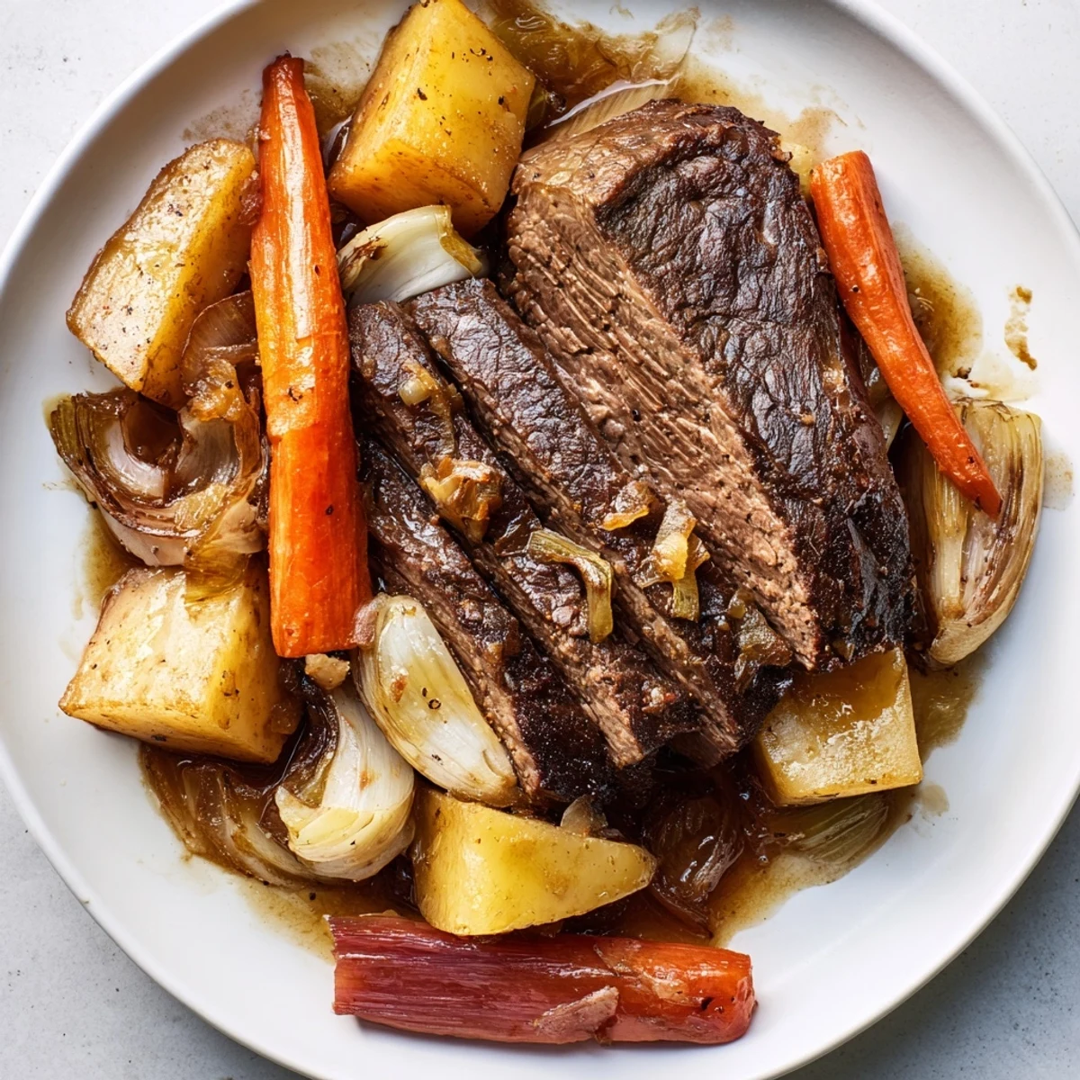 Sizzling close-up of Sunday Pot Roast, showcasing the fall-apart meat and vibrant roasted veggies.