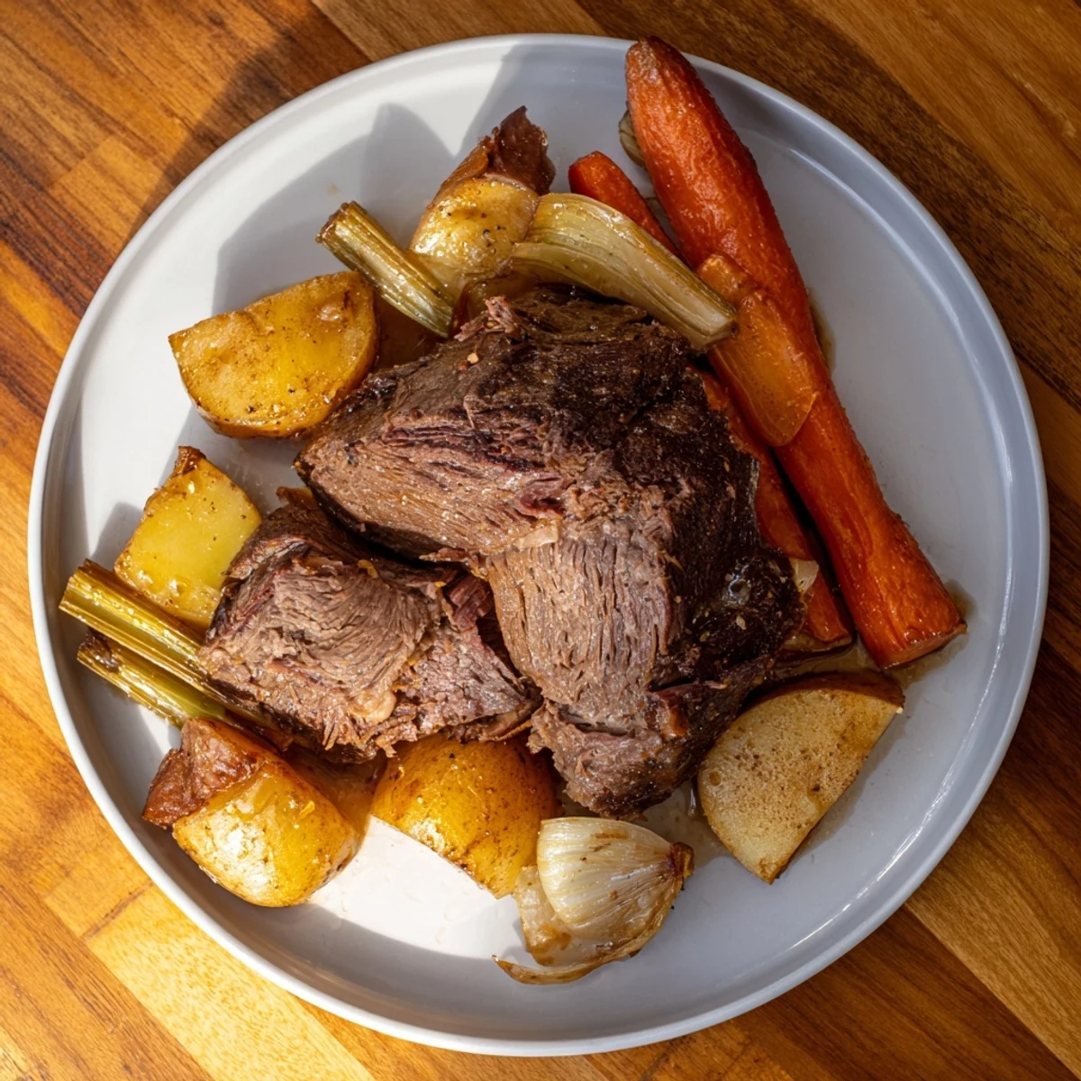 Juicy Sunday Pot Roast with potatoes, carrots, and onions, ready for a comforting weekend dinner.