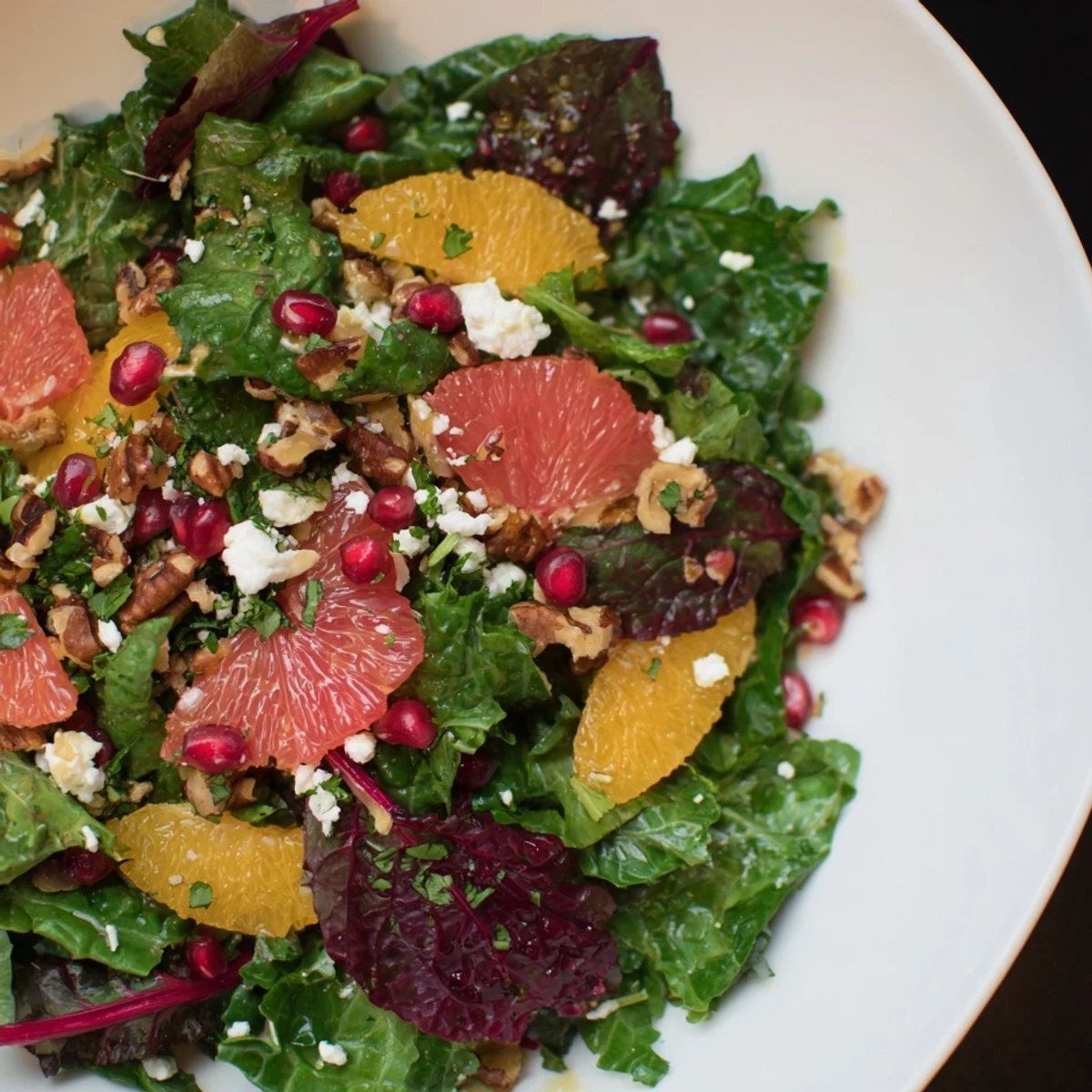 Winter Greens Salad with Citrus, Pomegranate, and toasted nuts, a colorful, refreshing medley.
