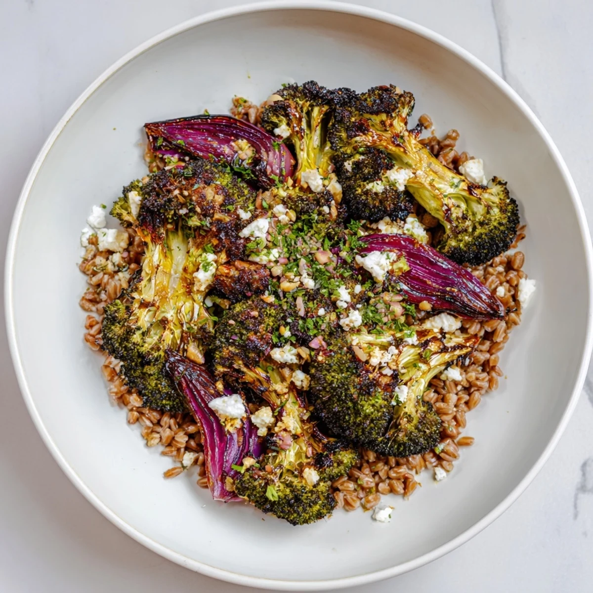 Golden, roasted broccoli and farro base, drizzled with lemon-garlic dressing, presents this delicious dish.