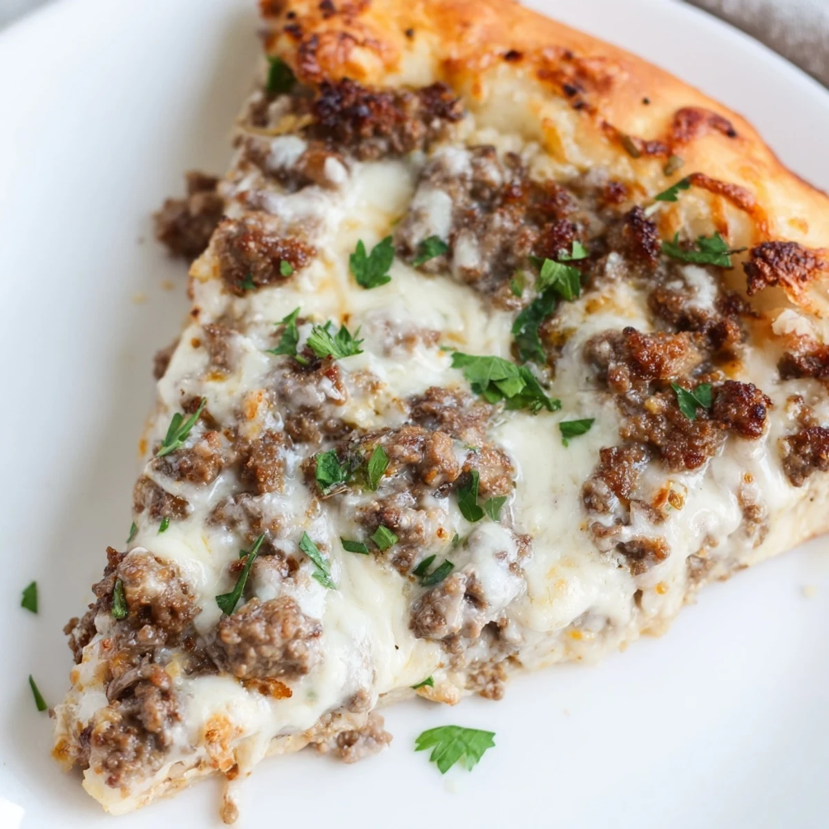 Golden, baked Ground Beef Alfredo Pizza, ready to eat, showing off a perfectly cooked, crispy crust.