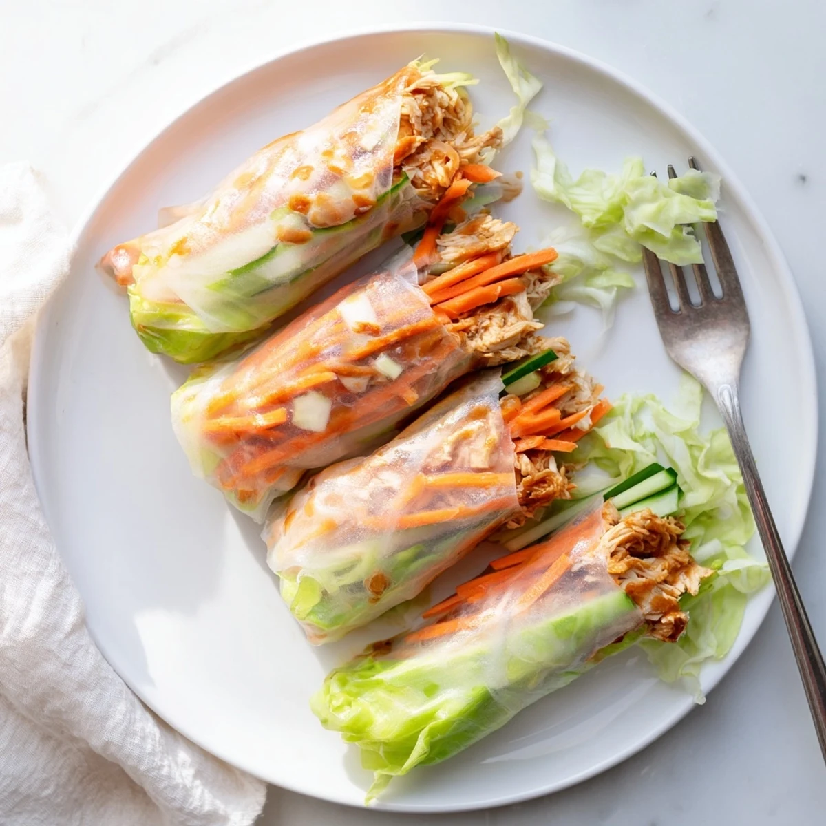 Golden, crispy Garlicky Pulled Chicken Wraps filled with tender shredded chicken and fresh vegetables, served warm on a rustic plate.  
