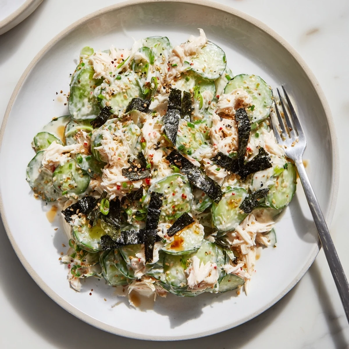 Creamy California Roll Cucumber Salad with shredded imitation crab, crisp veggies, and sesame seeds.