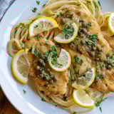 Bright and tangy Quick Chicken Piccata Pasta, served with a garnish of fresh parsley and lemon slices.