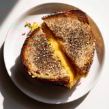 Crispy edges and melty cheese star in this Everything Bagel Grilled Cheese, served with a warm tomato soup.