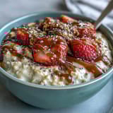 A jar of healthy overnight oats with strawberries and chia, perfect for a quick, nutritious breakfast.  