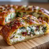 A golden Easter savory pie filled with creamy ricotta, ham, spinach, and whole hard-boiled eggs, baked in flaky puff pastry.
