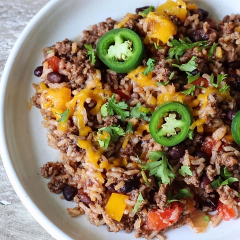 A bubbling Tex-Mex Beef & Rice Casserole, topped with melted cheddar, ready to scoop and serve.