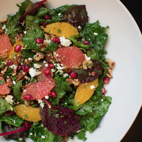 Winter Greens Salad with Citrus, Pomegranate, and toasted nuts, a colorful, refreshing medley.