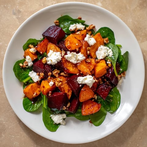 Brightly colored Roasted Beet, Butternut & Spinach Salad with creamy goat cheese and walnuts.