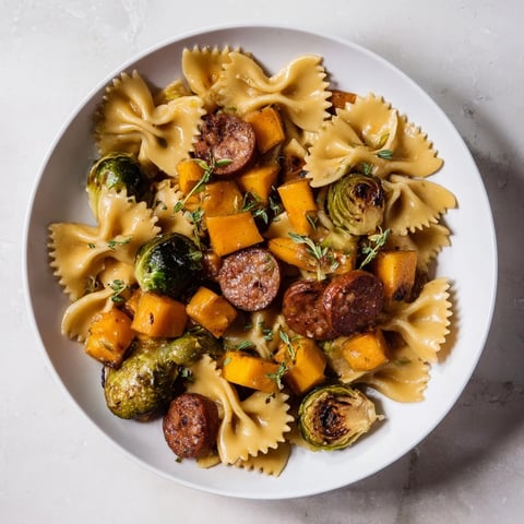 A close-up of Autumn Sausage Pasta Squash, showing tender squash, sausage, and bow tie pasta.