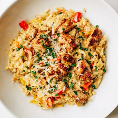 Tender chicken pieces and creamy sauce mingle in this flavorful One-Pot Cajun Chicken Alfredo Orzo.