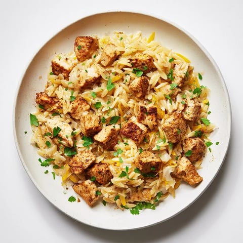Creamy One-Pot Cajun Chicken Alfredo Orzo features tender chicken and zesty sauce, ready in 30 minutes.