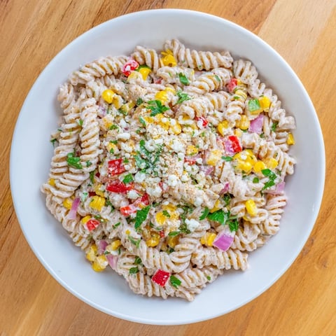 Vibrant Healthier Mexican Street Corn Pasta Salad with charred corn, ready to serve, looks amazing.