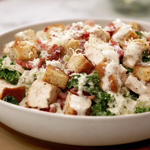 Costco Chicken Bake Salad Bowl brimming with juicy chicken, crispy bacon, and creamy dressing, ready to eat.