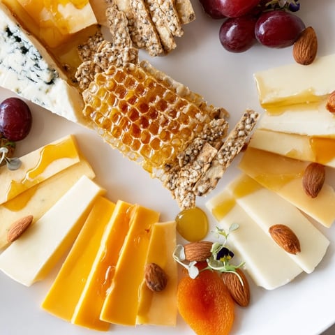 A visually appealing Gilded Hive cheese board with perfect hexagonal cheese and crackers arrangements.