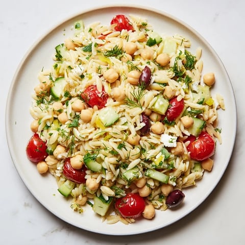 Bright and colorful Greek Lemon-Orzo Bean Salad with fresh vegetables, perfect for a light lunch.