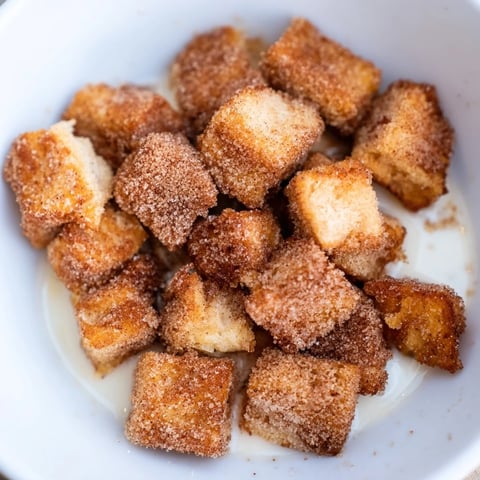 Golden-brown French Toast Cereal, crunchy and bite-sized, ready to be enjoyed with a splash of milk.