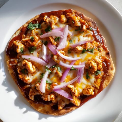 Golden-crusted BBQ Chicken Flatbread, loaded with melted cheese and fresh cilantro, is ready to serve.