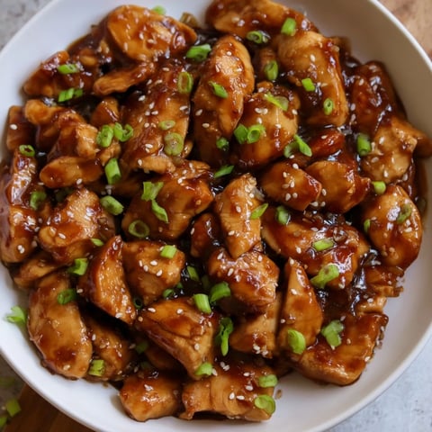 Golden-brown Sweet and Spicy Sriracha Honey Chicken, glistening with a vibrant, flavorful glaze.