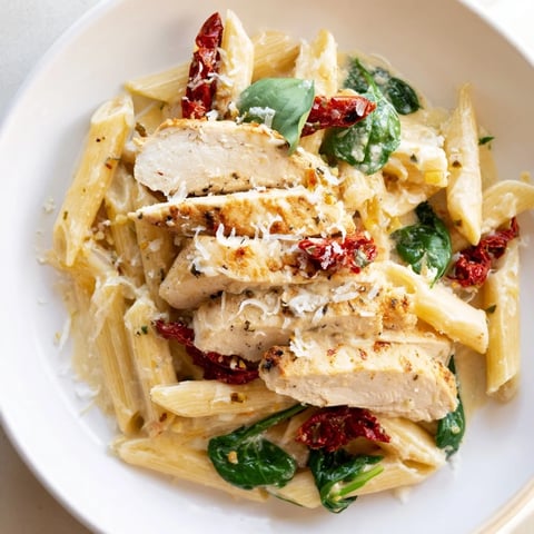 Creamy Tuscan Chicken Pasta, a delicious bowl showcasing tender chicken in creamy, rich sauce, ready to eat.