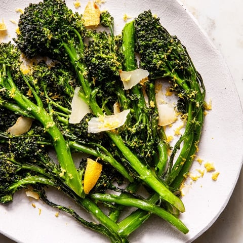 Air-fried Charred Broccolini Salad with crispy garlic, Parmesan, and bright lemon wedges provides a refreshing meal.