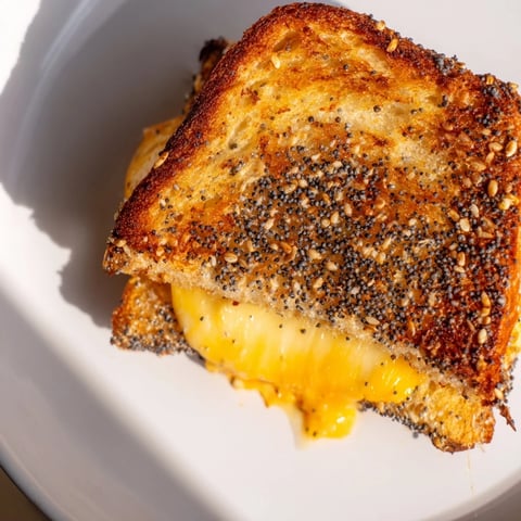 Crusty Everything Bagel Grilled Cheese, golden brown with melted cheese, perfect for a cozy lunch.