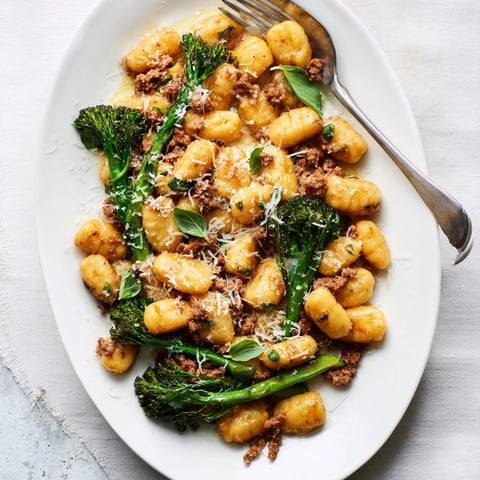 Golden roasted sheet pan gnocchi bake with savory sausage and crisp-tender broccolini, served hot from the oven.