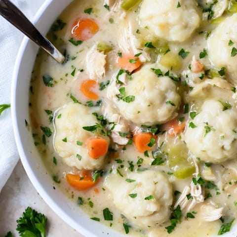 Tender chicken and fluffy dumplings create a cozy Classic Chicken and Dumplings meal.  