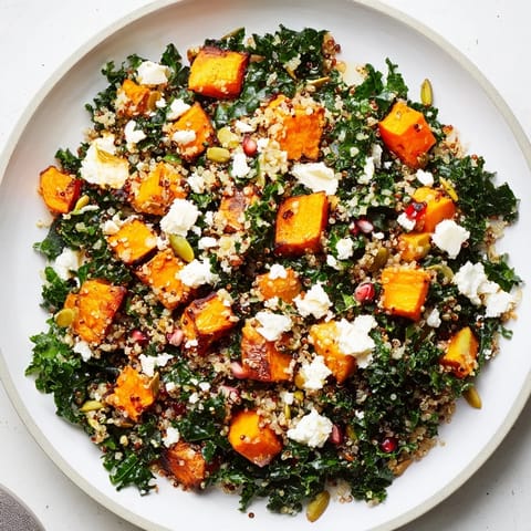 This delicious Kale & Quinoa Salad shows tender kale, fluffy quinoa, and bright pomegranate seeds after tossing.