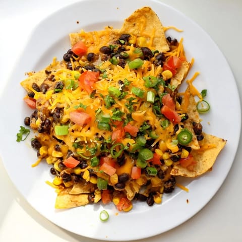 Golden, cheesy Sheet-Pan Nachos featuring spiced beans, crispy chips, and colorful toppings ready to enjoy.