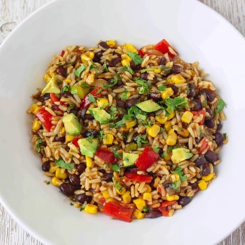 Freshly made One-Pot Mexican Rice & Beans with vibrant veggies, perfect for a fast weeknight dinner.