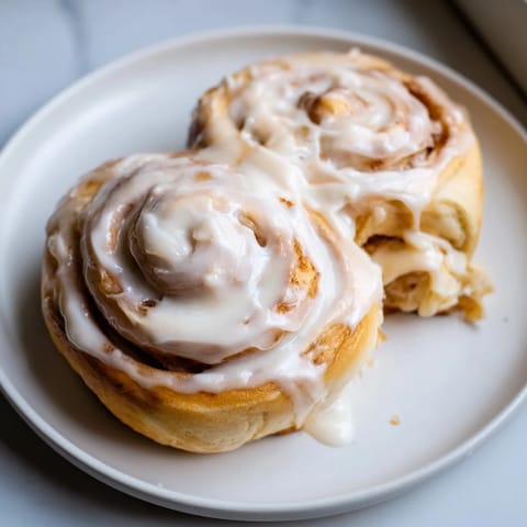 Warm, fluffy TikTok heavy cream cinnamon rolls offer a delightful swirl of cinnamon filling and cream.