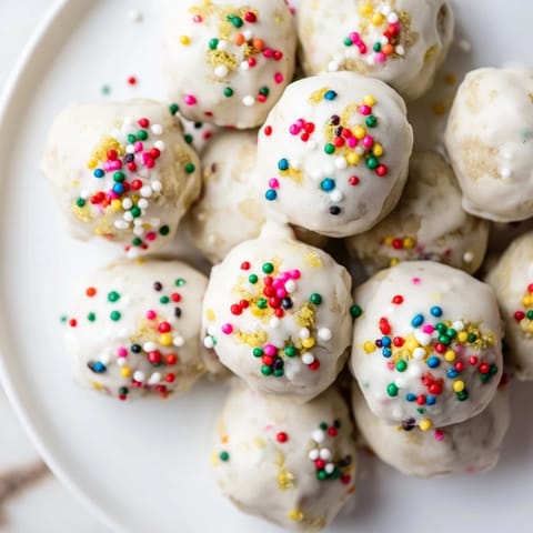 Freshly glazed Protein-Packed Italian Christmas Cookie Balls with colorful sprinkles, perfect for holiday gatherings.