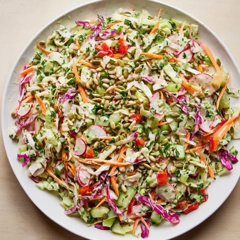 A bowl of fresh Green Goddess Confetti Chop Slaw, ready to serve as a delicious and healthy side.