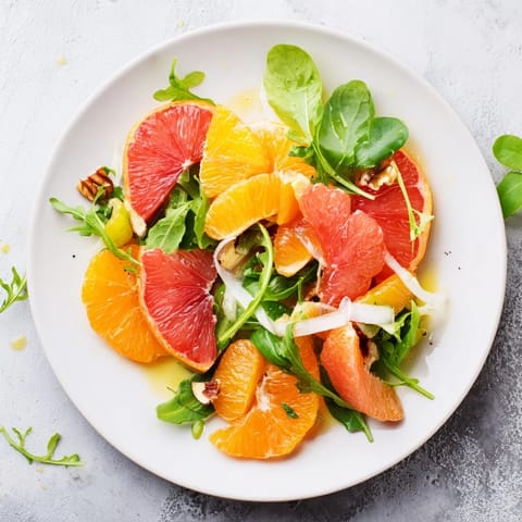 Freshly assembled Winter Citrus & Candied Pecan Salad: a colorful mix of greens, citrus slices, and toasted pecans.