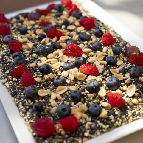 This eye-catching Singing Bird Seed & Berry Platter, with varied seeds and fruit, invites feathered friends to dine.