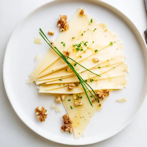 Close-up photo of a vibrant fan of Swiss cheese, perfectly layered and ready for an appetizer board.