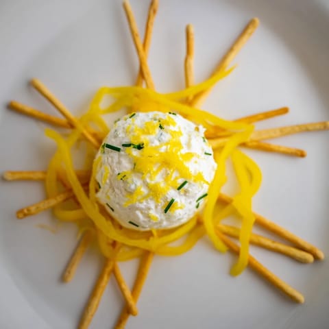 Lemon-infused goat cheese centerpiece of this delightful Tuscan Sunburst served with crisp breadsticks.
