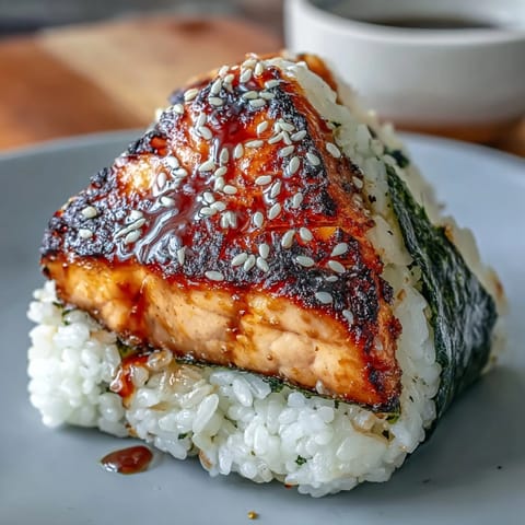 Grilled salmon onigiri with crispy exterior and savory filling, perfect for a light Japanese meal or snack.  