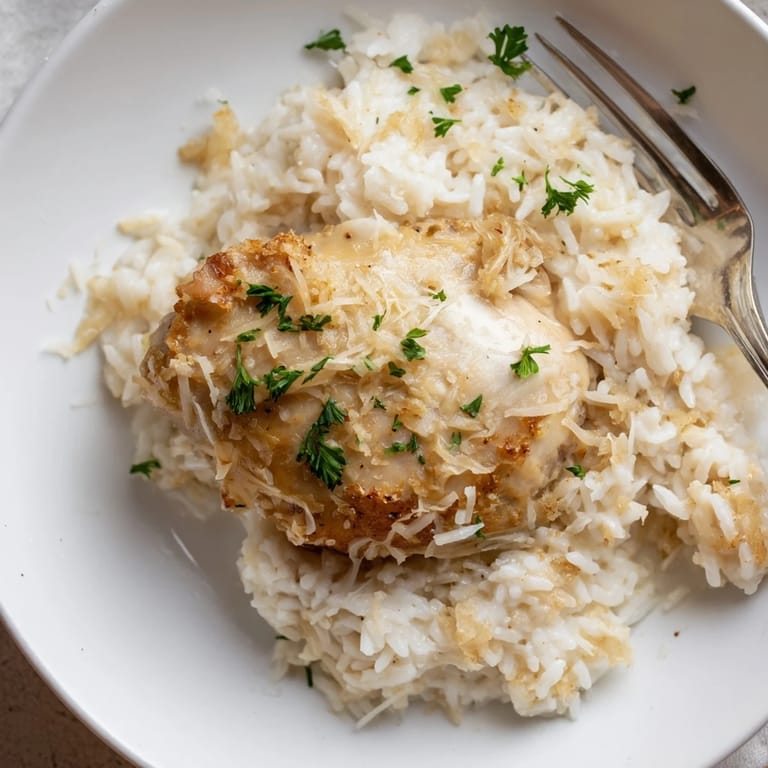 Sizzling chicken and aromatic garlic create a comforting One-Pot Garlic Parmesan Chicken and Rice dish.  