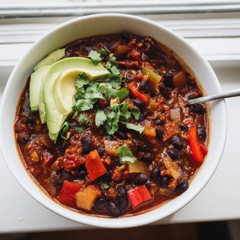 Hearty Spicy Black Bean Chili simmering with colorful veggies and robust spices.