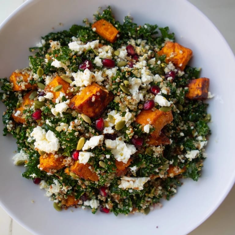 A close-up view of the Kale & Quinoa Salad with a drizzle of lemon dressing and toasted pumpkin seeds.
