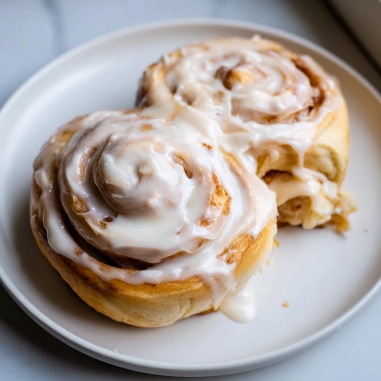 Warm, fluffy TikTok heavy cream cinnamon rolls offer a delightful swirl of cinnamon filling and cream.