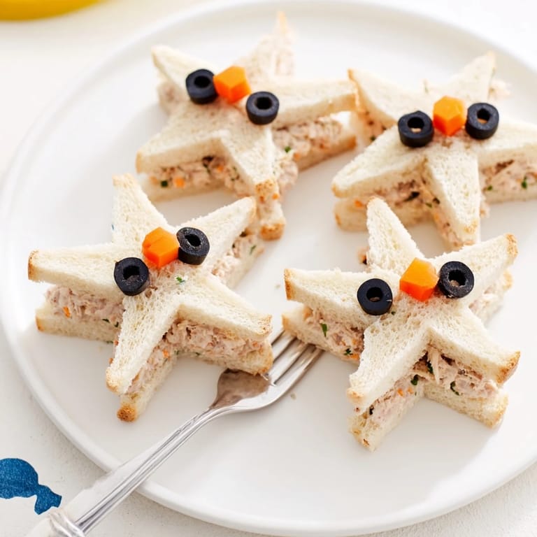 Freshly assembled Mini Starfish Sandwiches with tuna filling, ready for a kid's party platter.