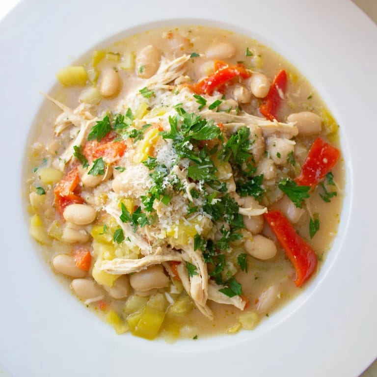 Savory White Bean and Roasted Red Pepper Chicken stew, with tender chicken and vibrant red peppers in a rich broth.