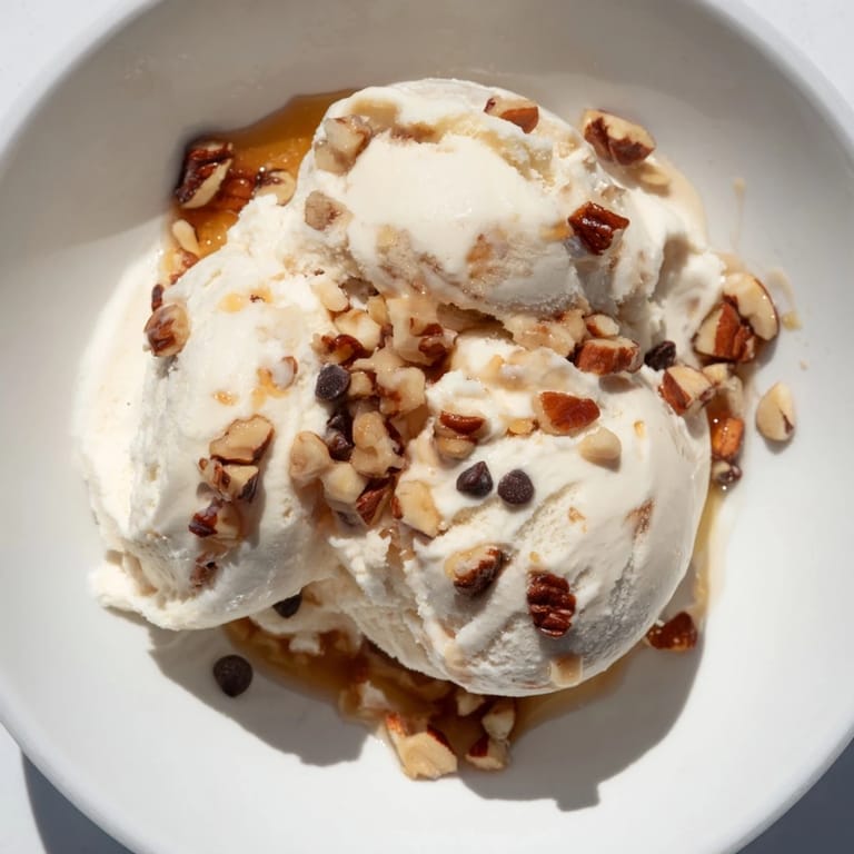 A bowl of homemade cottage cheese ice cream, ready to scoop, a sweet and tangy treat.