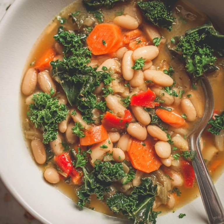 Warm Mediterranean White Bean Stew, a delicious vegan dish topped with fresh parsley.