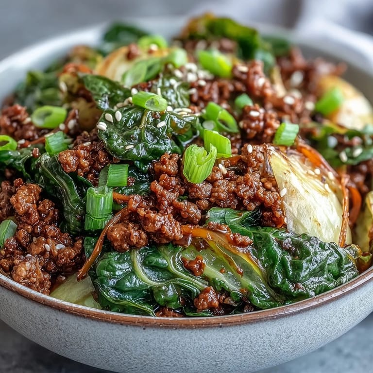 Tasty bowl of Chinese Ground Beef and Cabbage Stir-Fry, garnished with green onions and sesame seeds, ready for a quick weeknight family dinner.